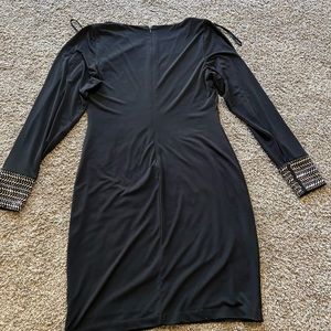 Black dress. Worn once. Sleeves have slits down the side. Size 4.